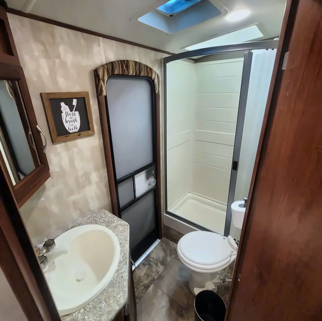 Bathroom with shower, toilet, and sink