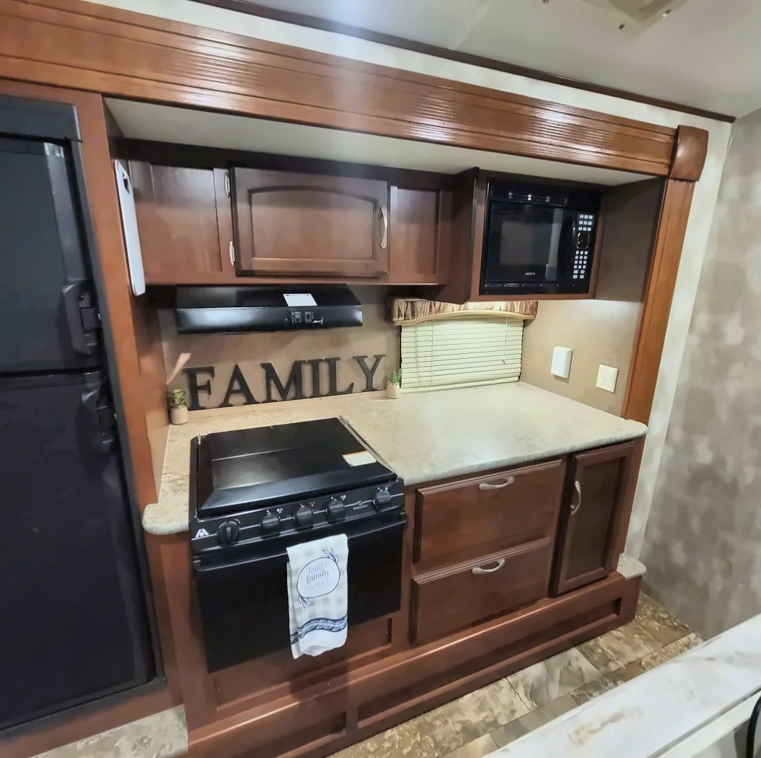 Slide-out kitchen with stove, oven, and microwave