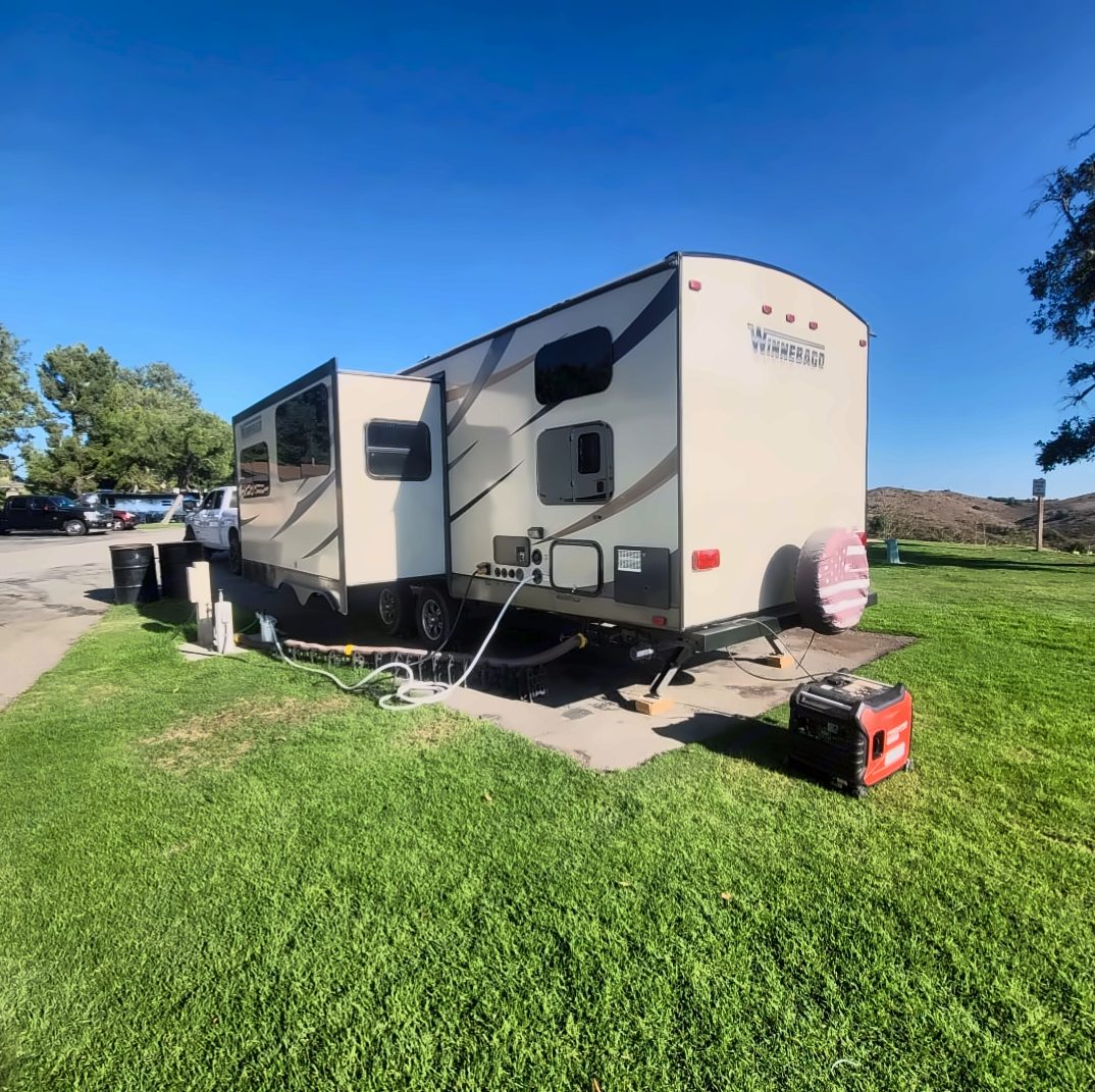 Trailer hooked up at a campsite with optional generator
